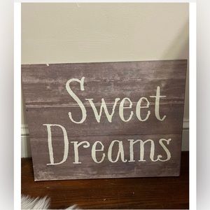 grey distressed “sweet dreams” sign.